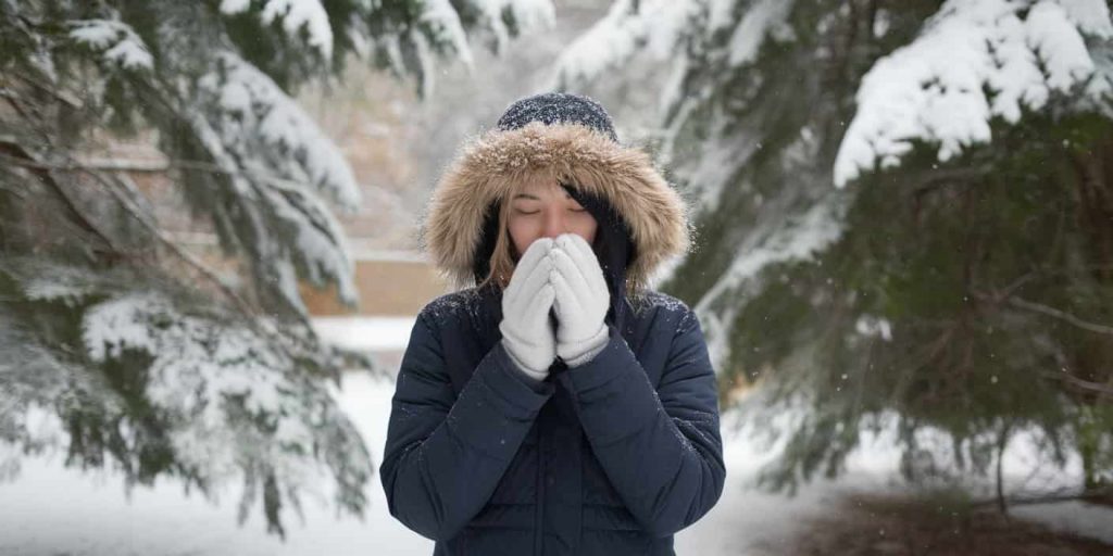 Person in a snowy forest, representing winter's lessons for spiritual growth