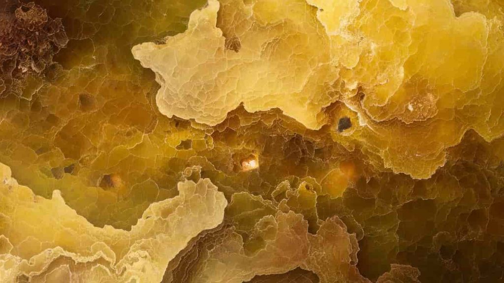Detailed view of yellow jade's surface showing color variations and patterns