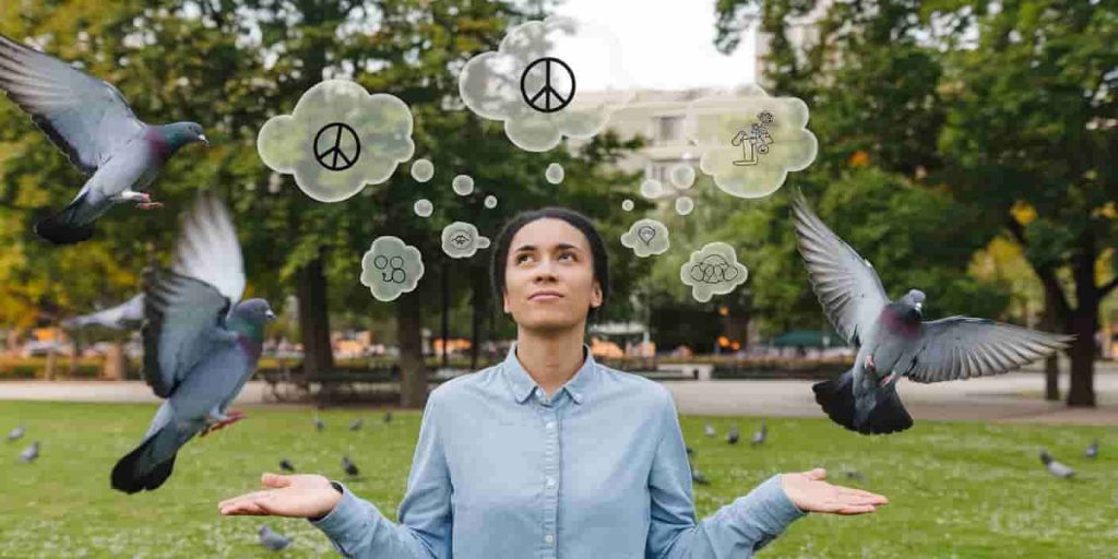 A person in a park surrounded by pigeons with thought bubbles containing symbols of peace, communication, and growth, depicting the spiritual lessons from pigeon encounters.

